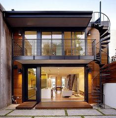 a modern house with stairs leading to the upper level