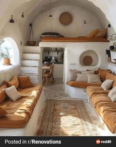 a living room filled with lots of couches and pillows on top of each other