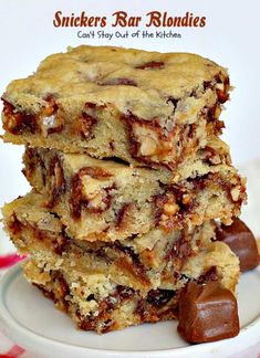 three pieces of snickkers bar blondies stacked on top of each other