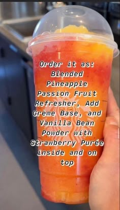 a person holding up a cup with orange juice in it that says order it as blended pineapple, passion fruit, refresher, and creme