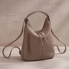 A bestselling convertible bag, Merrin is made for utility with easytoconvert straps turning it into your backpack purse and slouchy shoulder bag. Merrin Convertible Backpack In Pebbled Leather  Taupe BACKPACK in Taupe | Hobo® Convertible Backpack Purse, 2024 Wishlist, Convertible Backpack, Convertible Bags, Cool Backpacks, Taupe Color, Backpack Purse, Full Grain Leather, Pebbled Leather