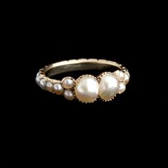 WHEN I FOUND this ring in London, I said the word "BOOBS". Is that where your mind goes, too? Lindsay is politely calling it "Toi Et Moi", which implies romance, too. The pearls are indeed voluptuous. MATERIALS: 14k gold (tests), 2 6 x 5.5mm pearls, 22 2.5mm seed pearls AGE: c. 1820 CONDITION: Very good - a few of the seed pearls along the hoop are replacements SIZE: 7, cannot be resized; 6.7mm head, 3.1mm shank Seed Pearl, I Said, Eternity Ring, In London, Romance, Size 7, London, Ring, Gold