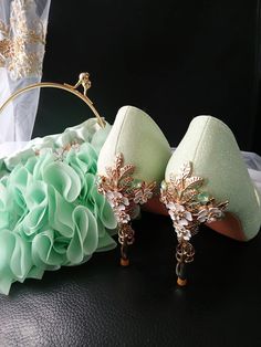 Add a touch of elegance and sparkle to your special day with this stunning set of Sage Green Glitter Bridal Shoes featuring delicate Cherry Blossom details. Paired perfectly with a matching Evening Clutch Bag adorned with soft Chiffon Flowers, this set is the perfect accessory for any bride or bridesmaid. Stand out and shine on your wedding day with this beautiful and unique ensemble that will surely make a statement. Specifications: Heel Height: 9cm Closure Type: slip-on Colour: sage green Size Flowers For Bride, Quinceanera Shoes, Correct Posture, Stunning Shoes, Bride Accessories, Chiffon Flowers, Posture Correction, Womens Wedding Shoes, Green Glitter