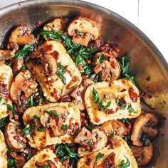 a pan filled with chicken and spinach covered in sauce