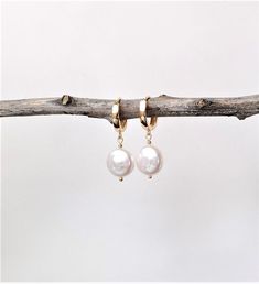 "All my earrings are sold as pair. If you would like one single earring please message me. Special offers: - orders over $100: free shipping upgrade to Parcel Post (no code required at checkout) - orders over $150: as above, PLUS 10% discount - enter code SPECIAL10 at checkout These dainty and elegant earrings will easily complement any outfit, by day or by night. They are beautifully lightweight and are sure to attract compliments! * natural freshwater pearls, round coin shape approx. 14mm diameter, slightly beveled on one side and flat on the other   * real 18k gold plated plated huggies, nickel free and tarnish resistant; inner diameter 12mm, thickness 3 mm * real 18k gold plated plated smooth beads, nickel free and tarnish resistant * real 18k gold plated ball pins   These are genuine White Pearl Earrings, White Pearl Bracelet, White Pearl Earring, Coin Earrings, June Birthstone, Earrings Minimalist, Single Earring, Matching Bracelets, June Birth Stone