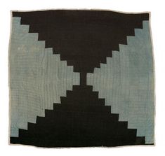 a black and white rug with an abstract design on the front, in two different colors