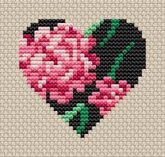 a cross stitch heart with pink flowers on it