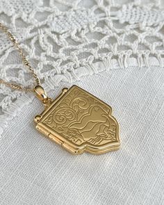 Beautiful Shield Locket Necklace with beautiful details. Gold plated silver locket and chain. Locket measurements 25.7mmx28mmx4mm. All items come in a gift box ready to gift. To see more please visit  https://www.etsy.com/shop/BijouLimon Bijou Limon jewelry collections present a romantic French spin on the latest jewelry trends. Based on the US West Coast but French at heart, Bijou Limon interprets the current jewelry trends and delivers timeless pieces that make you swoon. From Necklaces, Earrings, Bracelets, Rings and more, our Collections are filled with pieces that are both new and nostalgic. Find your unique accessories to complete your look. Personal Insight  What sets me apart? As a small business owner, I'm very conscious of keep every customer happily returning/ensuring client sup Wedding Jewelry Gold, Unique Locket, Chain Locket, Gold Shield, Latest Jewellery Trends, Silver Locket, Unique Accessories, Gold Locket, French Wedding