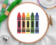 a cross stitch pattern with crayons on it