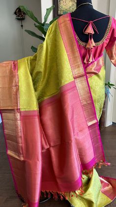 "Experience the luxurious elegance of our Parrot green KANJIVARAM SAREE. Handcrafted with pure kanchi gold brocade, this saree features intricate designs and pink gold borders. The heavy pallu and handwoven kanchipuram silk add to the opulence of this saree. Shop now from anywhere in the USA." Handcrafted with the finest vanasingaram saree kanchi pattu, this Pure fine weave parrot green KANJIVARAM SAREE features a beautiful pink brocade design. Its stunning hand embroidery on the blouse adds an elegant touch. Elevate your style and make a statement with this authentic piece. Parrow green KANJIVARAM SAREE with hand embroidered blouse Brocade kanchi pattu saree Fine weave hand woven pure zari kanchi pattu saree drapes like heaven Pure kanjivaram silk saree with Hand embroidered blouse. Blous Vanasingaram Saree, Green Kanjivaram Saree, Pink Kanjivaram Saree, Red Velvet Blouse, Readymade Blouses Online, Saree Drapes, Pink Brocade, Hand Embroidered Blouse, Silk Anarkali