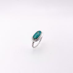 "A perfect everyday ring to mix and match with your other silver stacker rings! This delicate horizontal oval statement ring features a gorgeous natural variscite stone. Bezel set by hand and set atop a minimal dotted \"pebble\" band. Stack this ring with the other sterling silver dainty bands in my shop! * Size 6.5 * Statement setting is approximately 18mm x 10mm Ring band is 2mm wide *  *  *  *  *  *  Your piece will come in a jewelry box along with a polishing cloth to keep your piece sparkling! Please only use a polishing cloth to clean this Variscite ring.  Liquid solutions will negatively impact the stone. Hand crafted with sterling silver and stones set by hand.  This piece is one of a kind & made with care in my studio in Portland, Maine." Handmade Oval Stackable Rings For Everyday, Minimalist Oval Sterling Silver Stackable Rings, Everyday Oval Gemstone Stackable Rings, Minimalist Green Oval Stackable Rings, Modern Oval Turquoise Ring As Gift, Everyday Oval Sterling Silver Rings, Modern Oval Turquoise Gemstone Ring, Stackable Oval Emerald Ring In Silver, Oval Stackable Turquoise Ring Gift