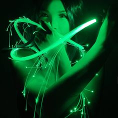 a woman with green lights in her hands