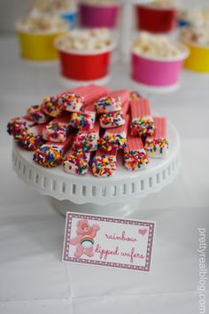 small cupcakes with sprinkles are on a cake plate