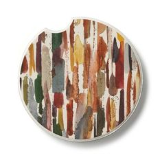 an oval shaped plate with multicolored paint strokes on the outside and inside of it