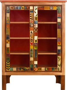 a wooden cabinet with many different designs on it