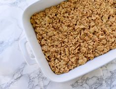 a white casserole dish filled with granola