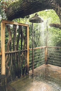 an outdoor shower in the middle of a forest