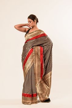 Expertly crafted for special occasions, our Red and Black Stripe Satin Silk Handwoven Banarasi Saree adds a touch of regality to your wardrobe. Shop now! Black Traditional Wear With Zari Weaving For Designer Wear, Black Traditional Wear With Zari Weaving For Designer Occasions, Festive Black Dupatta With Meenakari, Traditional Black Saree With Meenakari, Elegant Fitted Traditional Wear With Meenakari Details, Elegant Fitted Meenakari Saree, Elegant Fitted Traditional Wear With Meenakari, Black Brocade Traditional Wear With Zari Work, Black Meenakari Dupatta