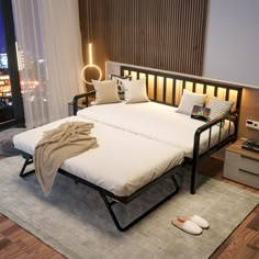 a bed sitting on top of a wooden floor next to a window