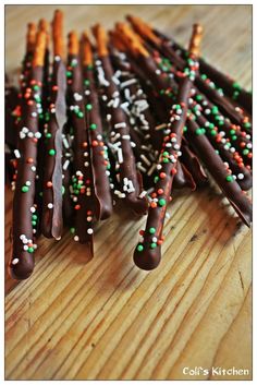 chocolate covered pretzels with sprinkles on a wooden table