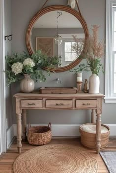 a wooden table sitting in front of a mirror on top of a hard wood floor