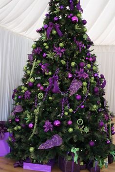 a decorated christmas tree with purple and green decorations