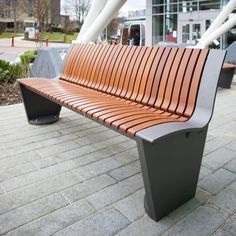 a wooden bench sitting on top of a brick walkway