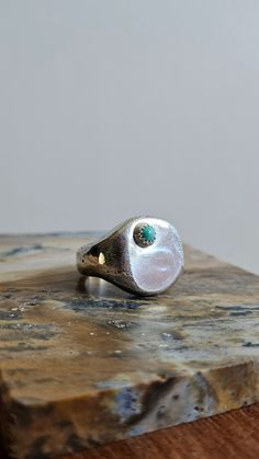 This signet is not for the faint of heart! It's half a troy ounce of sterling silver, sandcast in my home studio. A small kingman turquoise stone has been bezel set atop the face of the signet because it was just begging me for a little somethin' somethin' extra. *Fits a snug size 7* Handmade in sterling and fine silver. Patina and polished to highlight the natural texture from the sandcasting process. As always, please feel free to reach out if you have questions ~ Handmade Blue Sterling Silver Signet Ring, Elegant Turquoise Gemstone Signet Ring, Oval Turquoise Signet Ring In Sterling Silver, Blue Hallmarked Sterling Silver Signet Ring, Luxury Men's Turquoise Signet Ring, Kingman Turquoise, Natural Texture, Bezel Setting, Signet Ring