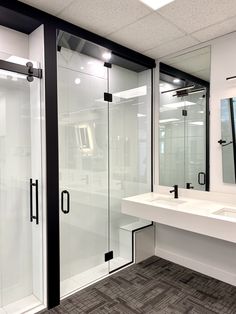 a bathroom with two sinks and a large shower stall next to a mirror on the wall