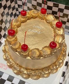 a golden cake with cherries on it