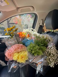 bouquets of flowers in the back seat of a car