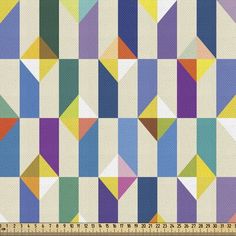 an image of a colorful geometric pattern on white fabric, with a ruler in the foreground