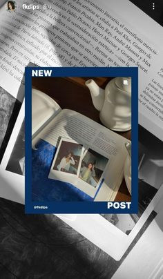 an open book sitting on top of a table next to a cup and saucer