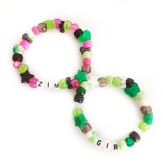 two bracelets with different colored beads and letters on the clasp, one for girls