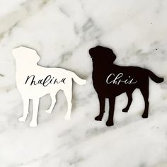 two black and white silhouettes of dogs on a marble surface with the word mama written in cursive writing