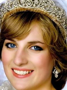 a woman with blue eyes wearing a tiara