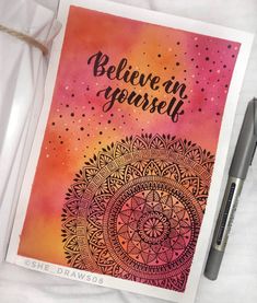 a card with the words believe in yourself on it next to a pen and paper