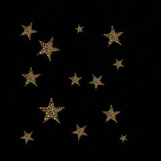 five gold stars are arranged in the shape of a circle on a black background with white dots