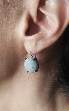 "These modern dangle  concrete  earrings are handmade from 925 silver  with oxidized finish.Τhe shape of the concrete is an round cabochon and its color is grey.Add a touch of modernity to your outfit with these round cabochon concrete earrings. In contact with skin, moisture and air, concrete becomes darker. Αs each piece is individually handmade, slight variations in texture are possible. DESCRIPTIONS and MEASUREMENTS: Materials:Oxidized silver. Surface: Concrete. Diameter:1,5 (cm) 0,59 (in)\". Total length: 2,3 (cm) 0,90 (in)\".                                            SEE MORE CONCRETE JEWELRY HERE: www.etsy.com/shop/ArtisJewels?ref=seller-platform-mcnav§ion_id=36353295 Visit my Etsy shop, ArtisJewels, to see more earrings and jewelry and other unique handmade pieces. www.etsy.com/sh Gray Drop Earrings For Pierced Ears, Minimalist Oxidized Dangle Earrings, Gray Sterling Silver Dangle Earrings, Gray Jewelry For Pierced Ears As A Gift, Gray Ear Wire Earrings For Gift, Gray Drop Earrings, Gray Drop Earrings For Gift, Minimalist Gray Sterling Silver Jewelry, Minimalist Gray Jewelry For Everyday