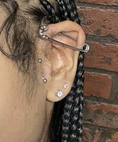 a woman with some piercings on her ear