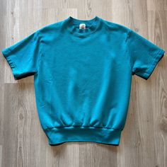 Vintage 90's Fruit Of the Loom Teal Blue Blank Sweatshirt Short Sleeve Tee Shirt Medium M Crewneck Pullover.  20x24 In very good overall condition. See photos for extra details. Feel free to message me if you have any questions! Oversized Blue T-shirt, Blue Oversized 90s Style Top, Oversized 90s Blue Top, 90s Oversized Blue Top, Retro Relaxed Fit T-shirt, 90s Style Oversized Blue Top, 90s Blue Oversized Top, Blue Vintage Tops With Relaxed Fit, Blue Vintage Tops Relaxed Fit