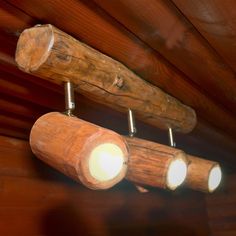 three wooden lights are hanging from the ceiling