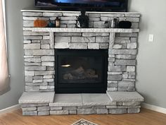 a fireplace with a flat screen tv above it