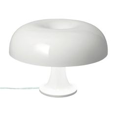 a white table lamp with a cord attached to it