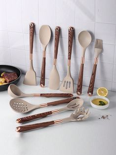 the kitchen utensils are lined up on the counter