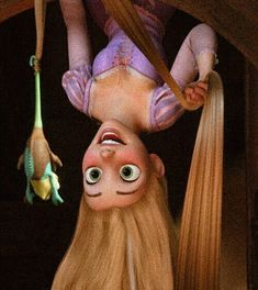 a woman hanging upside down on the side of a wall with two dolls attached to it