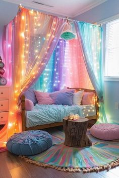 a room decorated with colorful lights and pillows on the floor, curtains are hanging from the ceiling