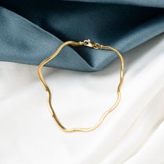 Our 14K Gold Snake Chain Bracelet is the epitome of sleek design and modern luxury. This handcrafted piece, with its distinctive flat snake chain, offers a smooth and comfortable fit, making it perfect for daily wear or special occasions. The high-quality 14K gold construction not only imparts lasting durability but also an undeniably elegant aesthetic. Available in various widths and lengths, this bracelet can be personalized to your exact preference for a snug or more relaxed fit. Key Features Flat Snake Chain, Gold Snake Chain, Snake Chain Bracelets, Gold Flats, Gold Snake, Classic Gold, Exquisite Jewelry, Snake Chain, Luxury Jewelry