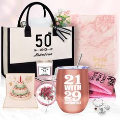 a pink and white gift bag, wine glass, birthday cake, napkins, and other items