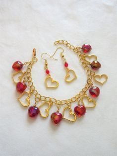 "This heart charm bracelet is an affordable gift of love or a Valentine's gift. It is made with 10mm puffed red rainbow hearts and 14mm gold plated heart charms. It is adjustable from 6. 5\" to 7.5\" inches. The matching earrings are made with 4mm red Czech beads and the gold plated heart charms. This set will be slipped into an organza bag and shipped in a bubble mailer." Gold Bracelet Set, Rainbow Hearts, Christmas Bracelet, Gifts For My Wife, Rosary Beads, Bubble Mailer, Valentine's Gift, Valentines Jewelry, Affordable Gifts